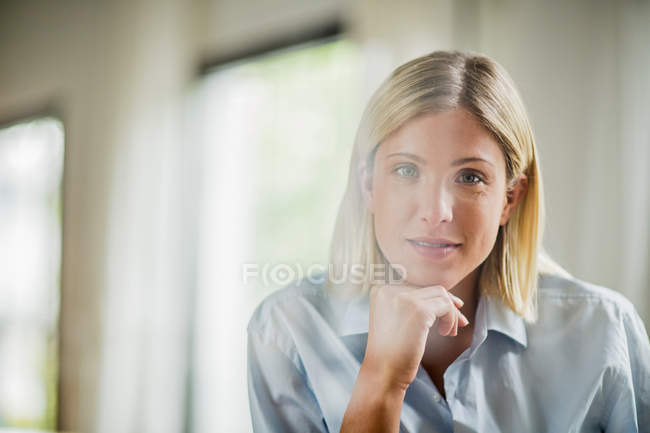 Portrait de belle jeune femme avec le menton sur la main — Photo de stock