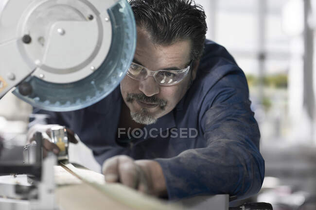 Cape Town, South Africa, elderly machinist measuring out dimensions on cutting machine — Stock Photo