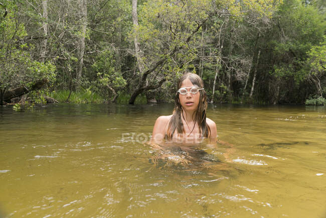 Teenage boy wearing swimming goggles in lake, Niceville, Florida, USA — Stock Photo