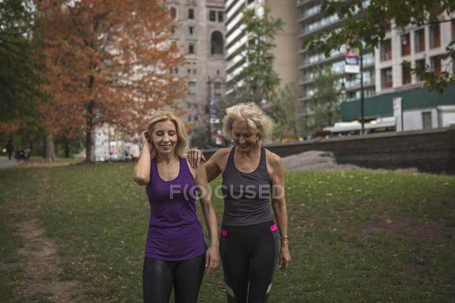 Duas amigas maduras treinando no parque, andando — Fotografia de Stock