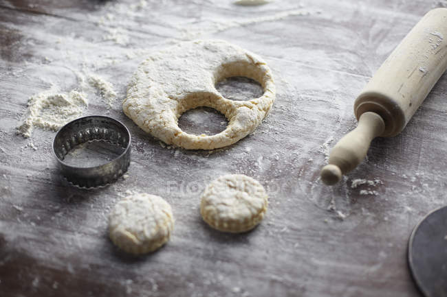 Baking preparation with scone dough and pastry cutters — Stock Photo