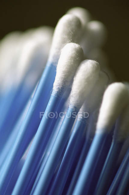 Close up shot of blue cotton buds on blurred background — Stock Photo