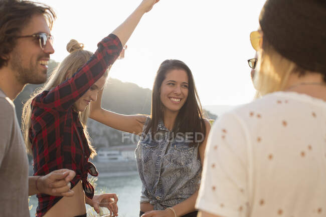 Adult friends dancing at roof terrace party on waterfront, Budapest, Hungary — Stock Photo