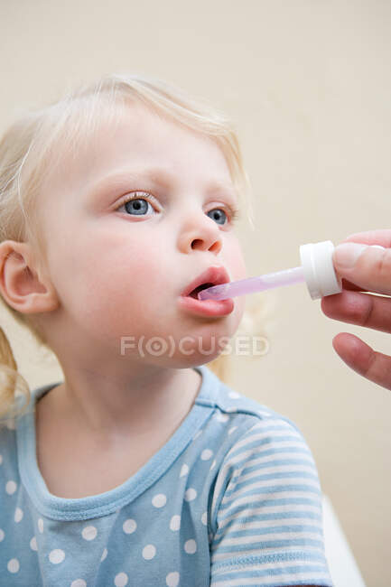 Little girl being given medicine — Stock Photo