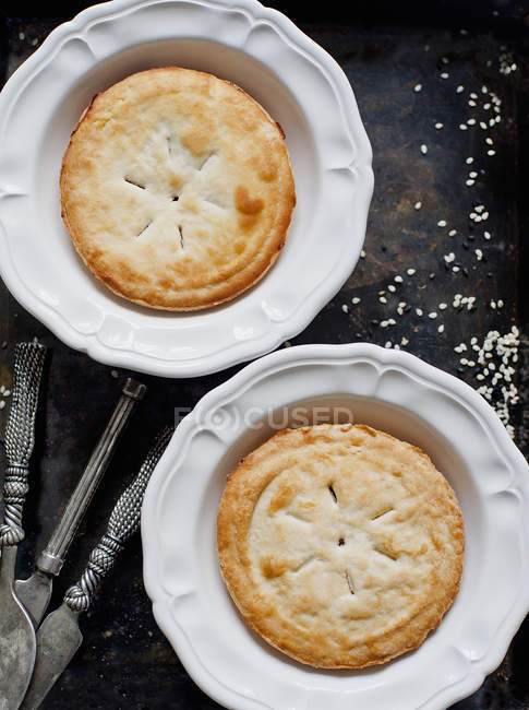 Two homemade pies on messy table — Stock Photo