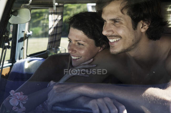 Couple in campervan smiling — Stock Photo
