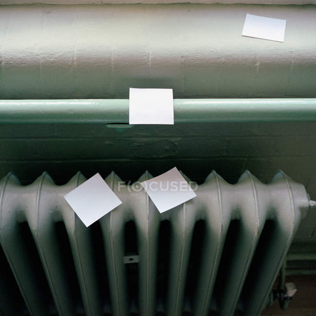 Elevated view of adhesive notes on radiator — Stock Photo