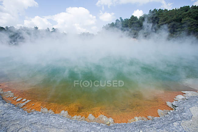 Steam floating above champagne geothermal pool — Stock Photo