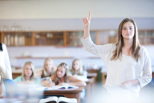 Student standing up to give answer — Stock Photo