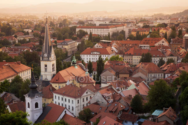 Church and rooftops at sunset — Stock Photo