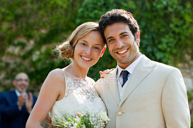Newlyweds at marriage ceremony, looking at camera — Stock Photo