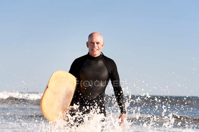 Portrait of Surfer in sea with surfboard — Stock Photo