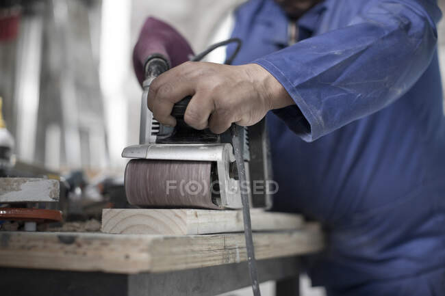 Cape Town, South Africa, machinist in workshop, sanding down wood — Stock Photo