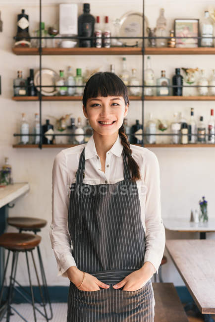 Portrait of female bartender in cocktail bar — Stock Photo