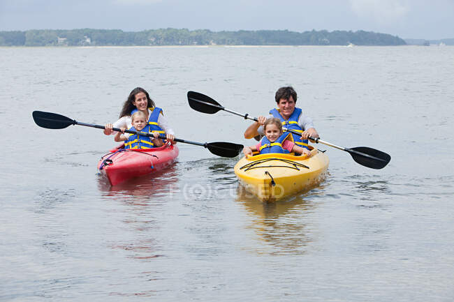 Couple and daughters kayaking — Stock Photo