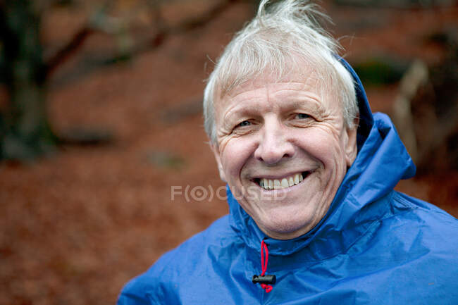 Senior man wearing waterproof clothing and smiling — Stock Photo