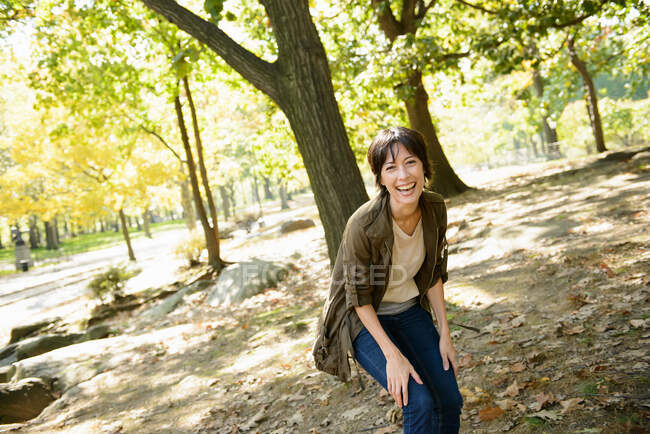 Woman laughing in park — Stock Photo