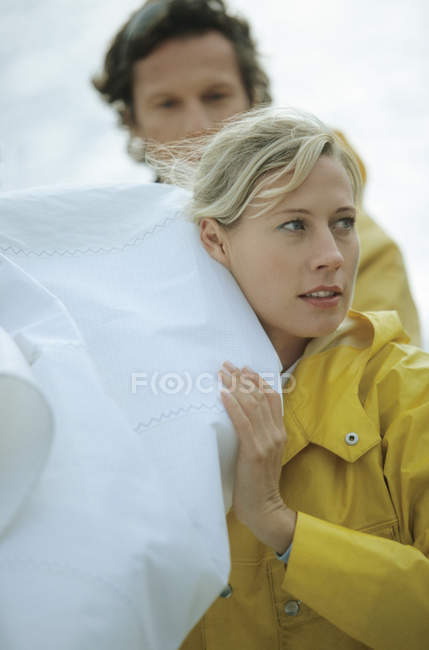 Portrait of Couple carrying sail — Stock Photo