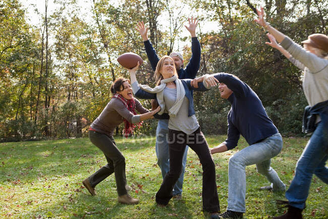 Mature friends playing football — Stock Photo
