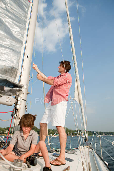 Father and son on board yacht — Stock Photo