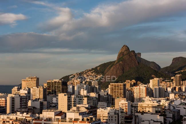 Aerial view of buildings beneath mountains, Leblon, Rio de Janeiro, Brazil — Stock Photo