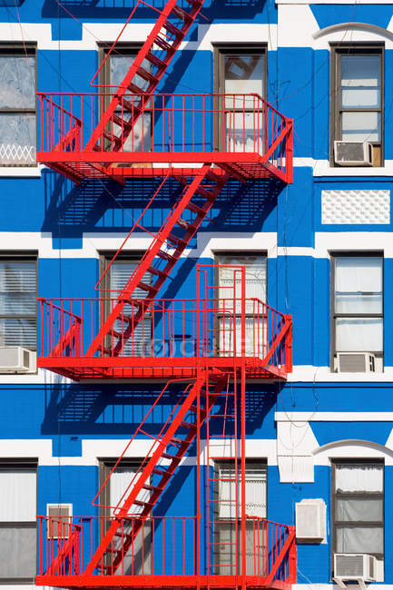 Apartment building with fire escapes — Stock Photo