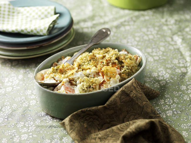 Root vegetable gratin in dish on table — Stock Photo
