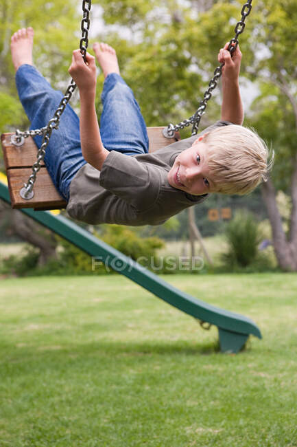 A boy on a swing — Stock Photo