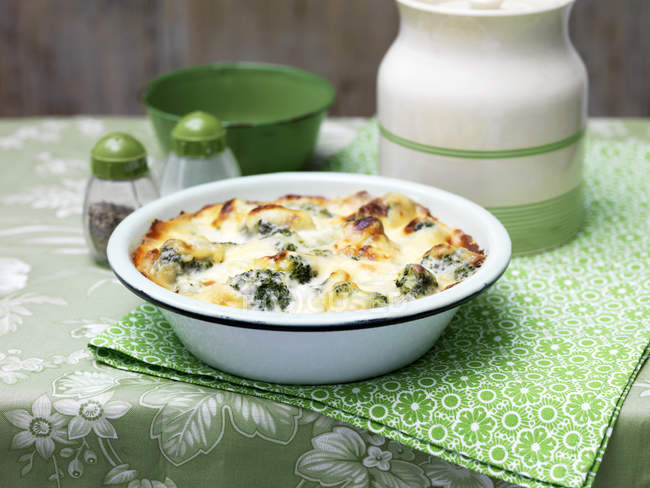 Broccoli and cheese bake in vintage bowl — Stock Photo