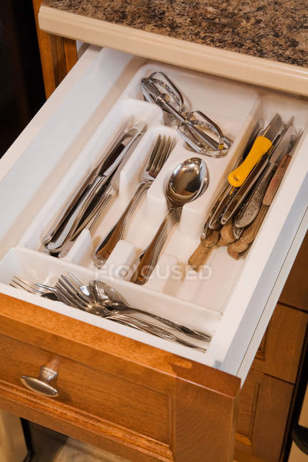 High angle view of cutlery in wooden drawer in kitchen — Stock Photo