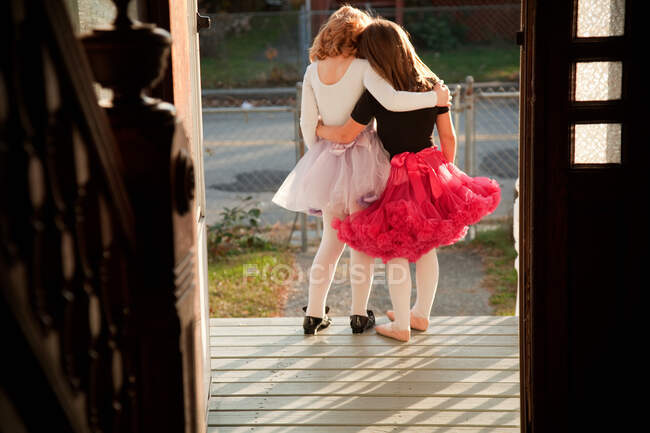 Girls standing together on porch — Stock Photo