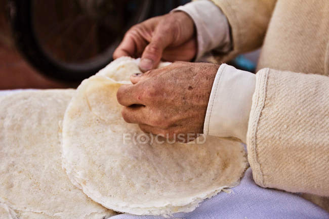 Hands of Brik seller, Houmt Souk, Djerba, Tunisia — Stock Photo