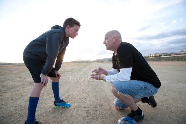 Boy and soccer coach — Stock Photo