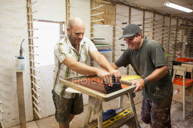 Männer drucken mit Siebdrucktechnik — Stockfoto