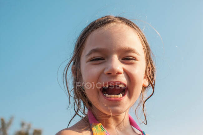 Happy girl against blue sky — Stock Photo