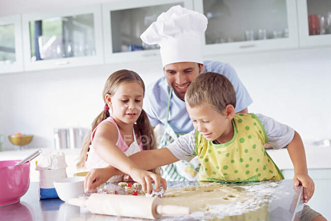 Father and children baking — Stock Photo