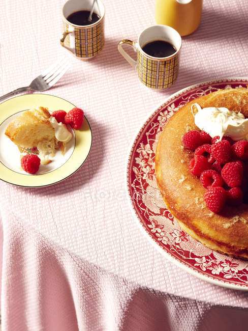 Savarin cake with raspberries and cream on table — Stock Photo