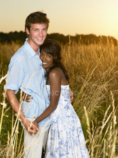 Couple at sunset,  in a field — Stock Photo