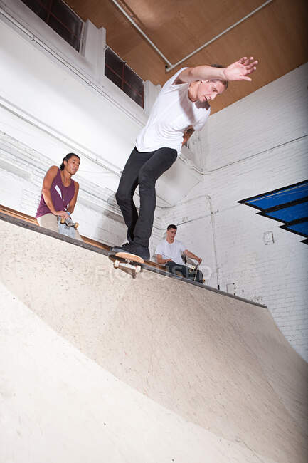Skateboarder sur la rampe au skate park — Photo de stock