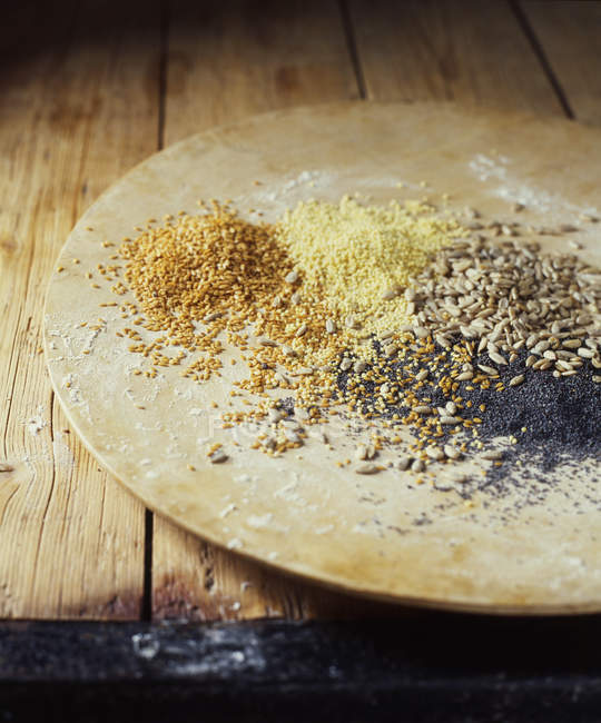 Plate with mix of poppy, sunflower and flax seeds — Stock Photo