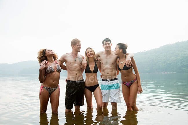 Retrato de amigos de pie en el lago - foto de stock