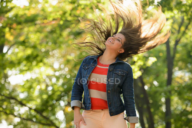 Mulher jogando seu cabelo no parque — Fotografia de Stock