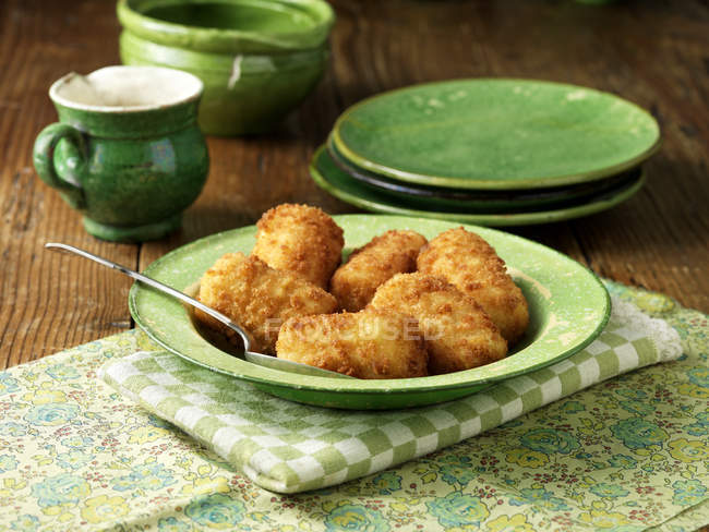 Potato croquettes in green vintage bowl — Stock Photo