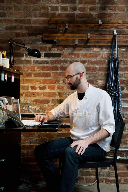 Butcher working on laptop — Stock Photo