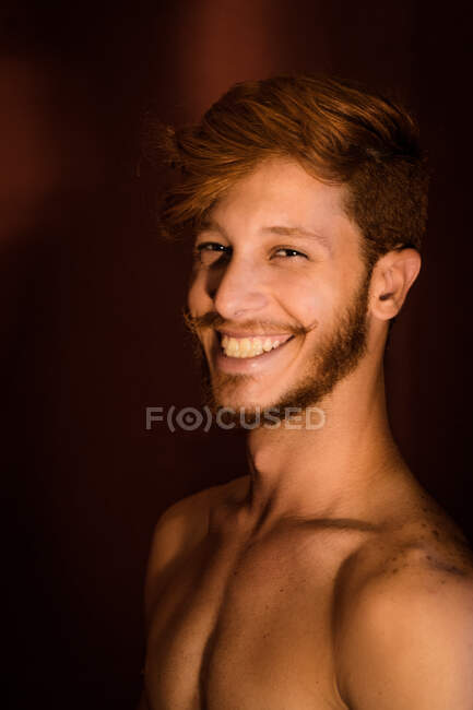 Portrait of young man with red hair, smiling — Stock Photo