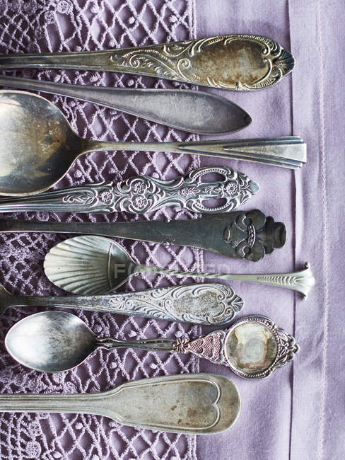 Design on antique-looking spoons and handles, top view — Stock Photo
