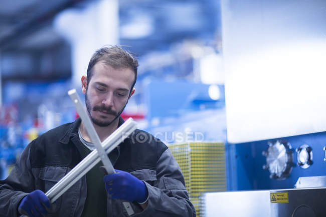 Young adult male Engineer inspecting components — Stock Photo