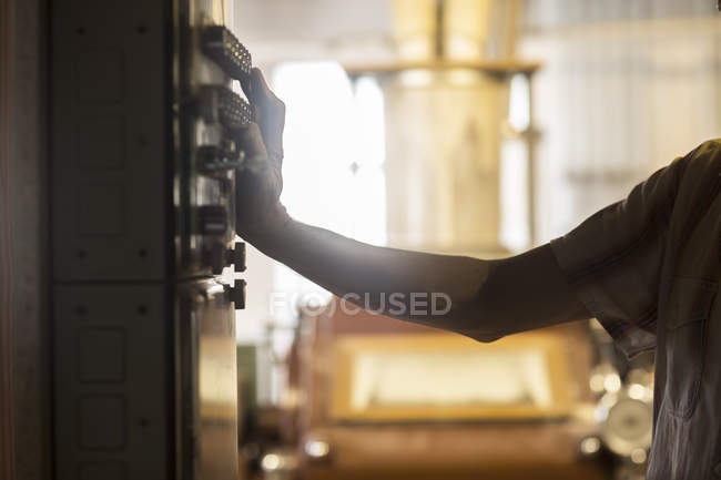 Hand of miller operating machine control panel at wheat mill — Stock Photo