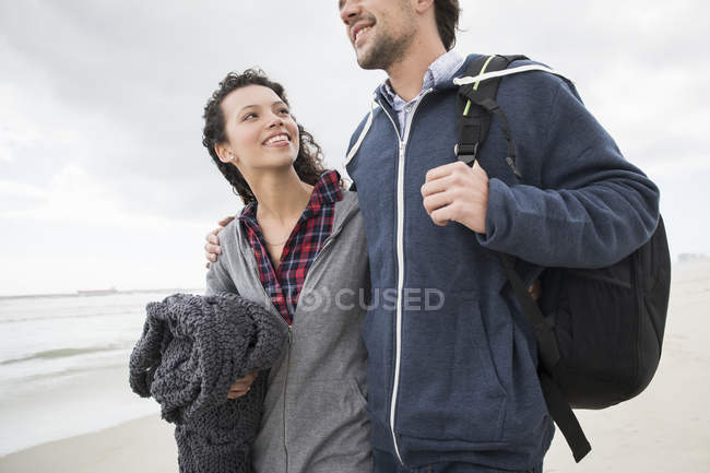 Romantic young couple strolling on windswept beach, Western Cape, South Africa — Stock Photo