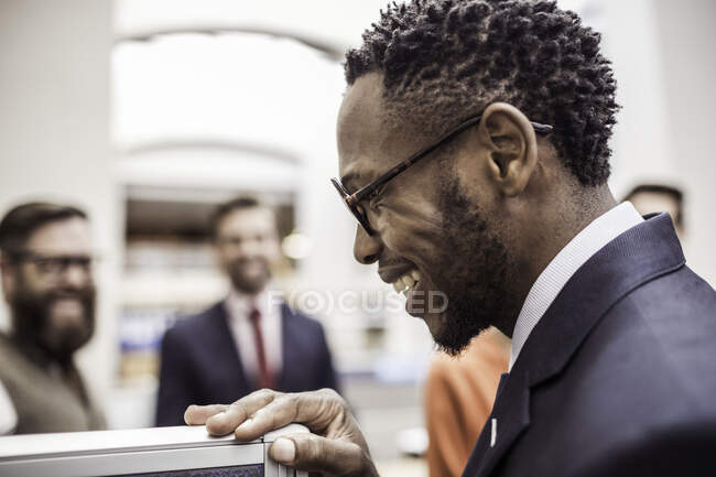 Profile of happy young businessman in office — Stock Photo